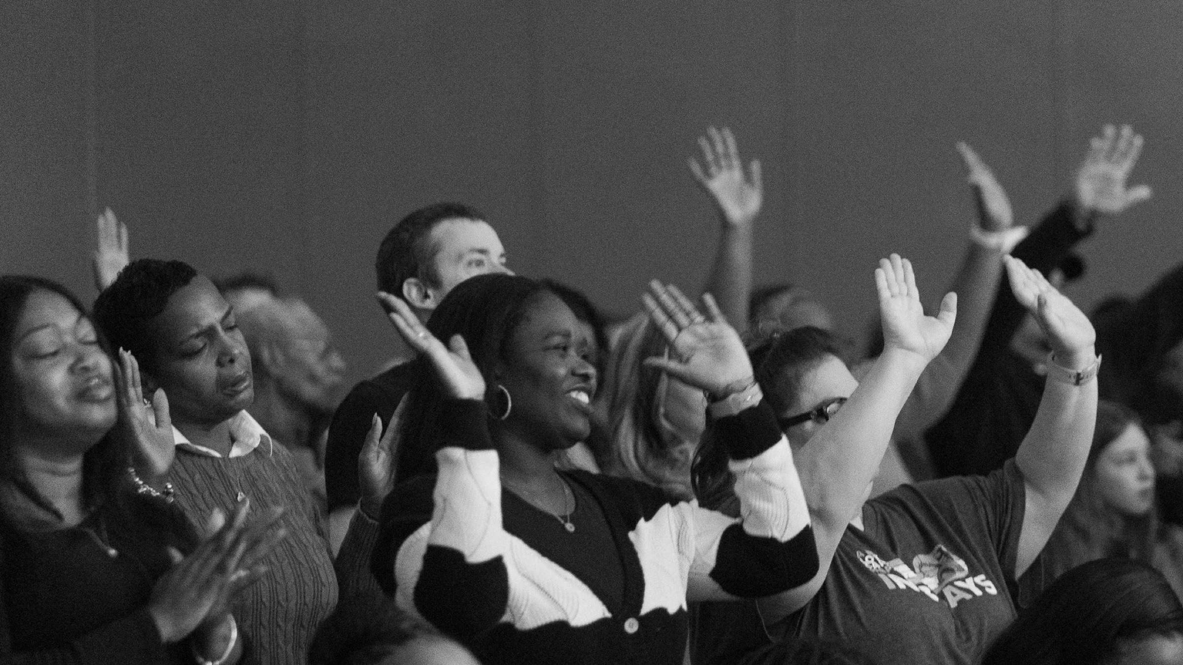 Worshippers with hands raised at Accelerate Church
