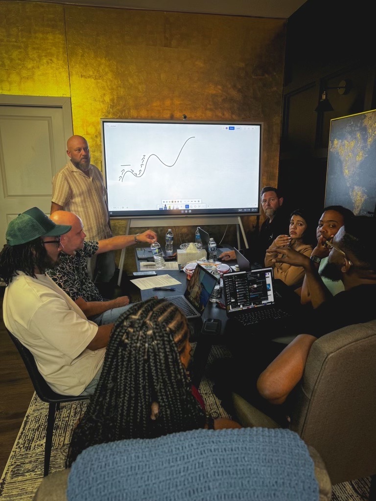 A church leadership team gathered around a screen during a One39 coaching session