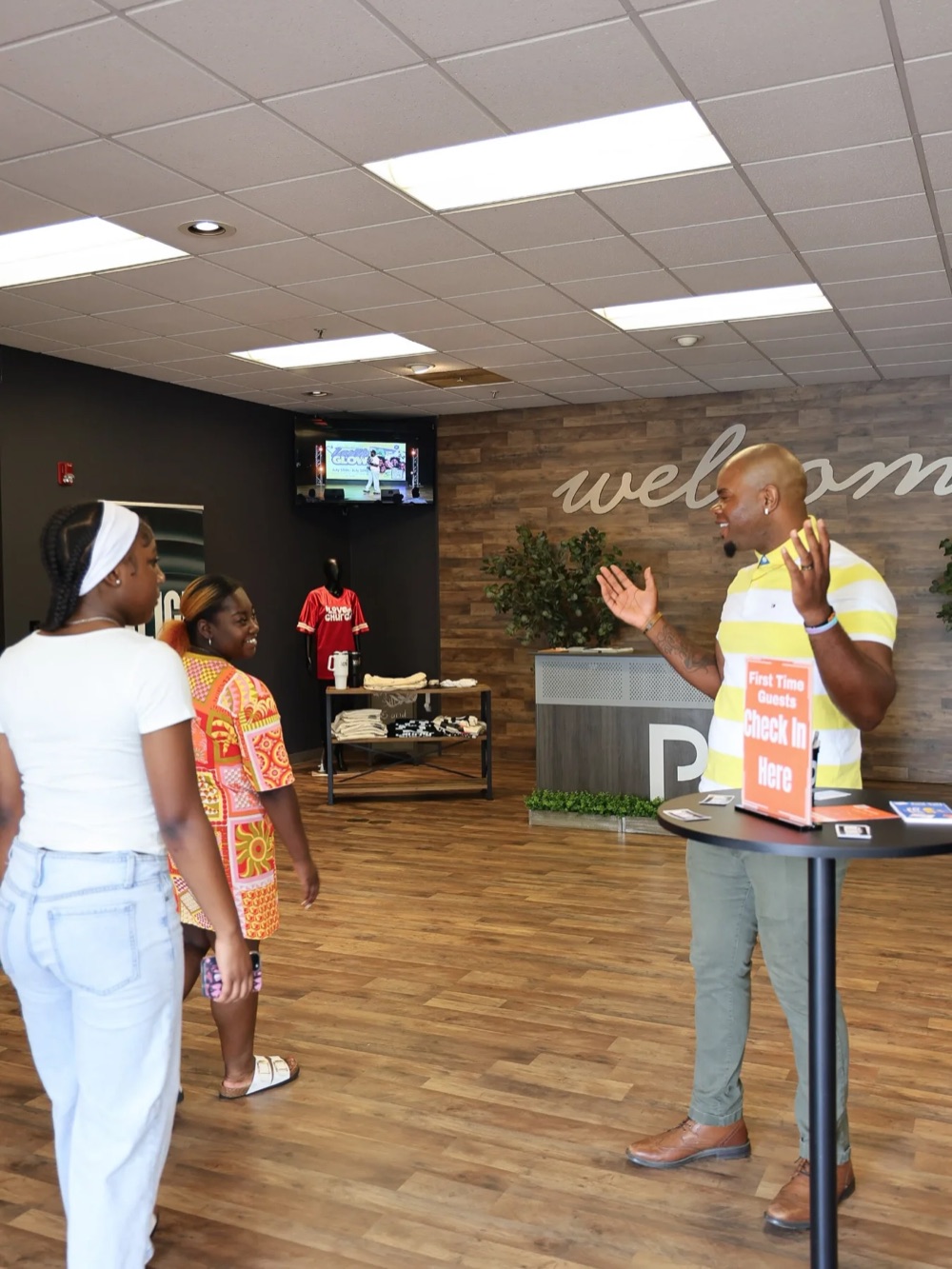A greeter welcoming first-time guests in the lobby at The Purpose Place